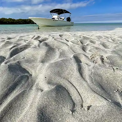 Boat anchored at Marvin Key Sandbar with clear waters