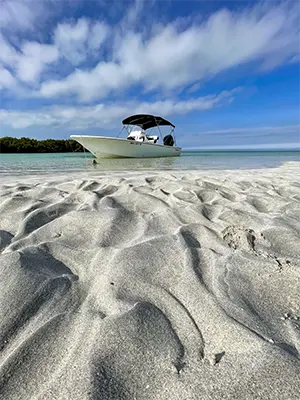 Boat anchored at Marvin Key Sandbar with clear waters